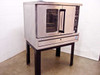US Range CG-100 commercial gas convection oven angled front-right view showing full unit on stand with door handle and control panel