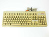 Compaq 121740-001 104-key PS/2 keyboard, beige, full top view with attached PS/2 cable