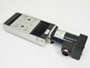 AeroTech 100-50-u-20P Accudex Motorized Linear Stage with 101SMB2-HM stepper motor — front-left three-quarter view showing carriage, bellows, and circular multi-pin motor connector