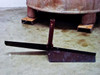 Separate T-bar paddle agitator/mixer assembly laid out on floor in front of tank on steel pad feet