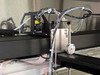 Symyx Technologies S14100 – close-up of robotic Z-axis arm assembly with Hitachi CCD camera, drive motor, and fluid tubing bundle