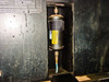 Sun Electric MRC 400 interior showing cylindrical filter-drier canister with yellow warning label and blue refrigerant hose