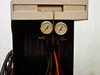 Sun Electric MRC 400 front lower section showing two analog pressure gauges (low-side and high-side) and multiple service hoses