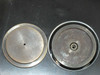 Harris/Farinon 1107 — two 2.25-inch wafer chuck discs shown side by side: flat plain disc (left) and disc with center vacuum port fitting (right), both showing metallic wear
