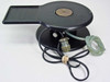 Harris/Farinon 1107 heated wafer chuck — front 3/4 view showing 2.25-inch circular vacuum plate, rectangular tray extension, black body, multi-pin mil-spec connector, and clear pneumatic tubing