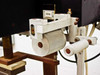 Foil feed roller and guide mechanism close-up showing knurled rollers and adjustment hardware