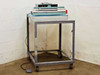 AIE AIE-605A1 24-inch impulse heat sealer mounted on rolling steel cart, full side view in warehouse
