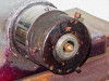 Close-up of spindle chuck end showing surface rust and wear on spindle housing and face