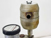 Edwards foreline trap close-up – showing cylindrical body with side port opening and top cap with wing-nut, heavy external surface oxidation