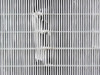 Close-up of HEPA filter media showing damage — torn and crumpled filter material, confirming pre-filter/HEPA replacement needed