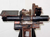 Front view of F&B/CECO film splicer splicing head with small red label visible on the cylindrical body component