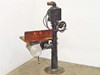 Bell and Howell Model D film printer stand full-length side profile view on round cast iron base showing printer head and work table
