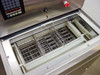 ITS UC-7010 Wafer Box Washer – top-open view of stainless wash chamber with three stainless wire wafer box baskets installed