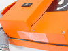 Close-up of cracked orange plastic housing with tape repair visible at seam