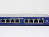 Netgear FS108 front port view showing 8 RJ-45 ports, Auto 10/100 Mbps Switching label, and Auto Uplink indicator on port 8