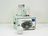 Mattson-Garvin Model 200 air sampler rear view — power cord coiled in rear compartment, blue model/serial label, Pall disposable filter assembly attached to side port