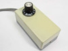 Bausch & Lomb light intensity controller — top view of cream-colored dial controller box with numbered rotary knob (1–10 scale) and cable