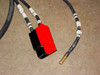 Anderson-style high-current DC connector (red/black) and individual cable lead with gold pin terminal