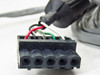 Close-up of PGT PRISM60 control cable multi-pin connector end showing red, green, white, and bare wire terminations