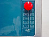 JST DT921E EPO control panel close-up showing red mushroom EPO button, status indicators (EPO, Alarm 1, Alarm 2, Alarm 3), and System buttons (Main, Sys, Power On, Power Off)