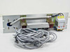Riber 3.B220TRI panel rear view showing bus bar assembly, red terminal blocks, three-pole contactor or breaker, green/yellow earth wire, and long gray cable harness spread out