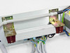 Rear panel detail showing bus bar with red ceramic/bakelite insulators, mounting brackets with oxidation/patina, gray wiring harness with blue, brown, green/yellow conductors