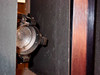 Close-up of incandescent side wall bulb socket inside CRP L-207-B chamber interior — dusty socket with clip-style lamp holder