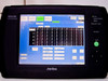 Anritsu MD6430A front panel with touchscreen LCD displaying Measure/Analyze screen with character data table — panel lock, battery, and print now indicators visible on right side