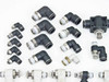 SMC pneumatic fittings close-up — elbow, tee, and speed controller fittings in black and white body styles with threaded metal ends