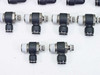 SMC black elbow speed controller fittings — five units close-up from slightly different angle showing threaded male ends and push-in collet detail