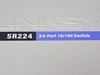 Linksys SR224 — close-up of top lid label reading SR224 24-Port 10/100 Switch with embossed Linksys text