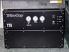 TTI TriboCop main unit front panel — 'TriboCop' and 'TTI' branding, three analog pressure gauges labeled Clamp, Spindle, and Line with Regulator labels, main power switch, and Power/Air/Index/Clamp LED indicators