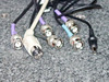 Close-up of BNC and signal cables included with the TTI T9000 TriboCop Spinstand system — multiple BNC connectors in purple, white, black, and teal, plus a small circular DC connector, resting on granite plate