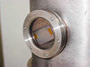 Close-up of bell jar sidewall viewport with KF flange and glass window — interior shows deposition residue on glass