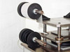 Close-up of upper film roll arbors and laminating platen showing rubber idler wheels and stainless steel work surface
