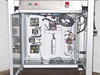 Interior electronics bay with cabinet door open showing control boards, Mean Well PS-150-24 power supply, wiring harness, and pneumatic components