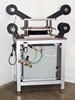 Full side/rear three-quarter view of laminating press station showing pneumatic plumbing, SMC components, and film roll arbor assembly