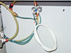 Underside pneumatic plumbing detail showing color-coded polyurethane tubing, brass fittings, and manifold block