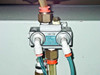 Close-up of Mead Nova 1 NS-DP pneumatic valve with brass fittings and polyurethane tubing connections