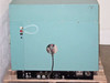 LFE PFS/PCrE/PDS-501 — rear view of full cabinet showing teal sheet metal enclosure, two indicator lights and power cable on rear left panel, large round power inlet cutout, and base-mounted regulator/control panel