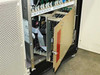 Card cage door open showing multiple populated PCBs and a red warning label