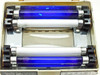 Luxo 0316040 interior bulb compartment open showing two blue UV fluorescent tubes and two white fluorescent tubes illuminated