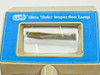 Luxo 0316040 close-up of front panel showing blue label reading Ultra Violet Inspection Lamp and magnifying glass window