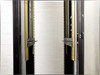 Close-up of 37U rackmount cabinet interior showing dual vertical EIA rail pairs with gold zinc-plated rails and adjustable mounting brackets
