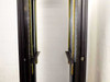 Dual vertical rail close-up inside 37U rackmount cabinet showing gold EIA-standard mounting rails and cable management channel