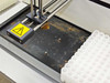 Autosampler probe station area showing heavy corrosion and staining on the drip tray surface