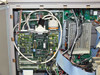 Interior close-up – main controller/processor board with multiple ICs, ribbon cable connections, and internal PSU visible