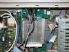 Interior close-up – internal power supply modules with perforated enclosures, wiring harnesses, ribbon cable, and additional PCBs