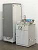 Rear view of both Auto 500 units showing back panels, casters on control cabinet, and chamber unit rear plumbing connections