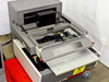 Seiko SFT7300 XRF gauge head — top open, interior sample stage and drive mechanism visible, X-RAY label on tray
